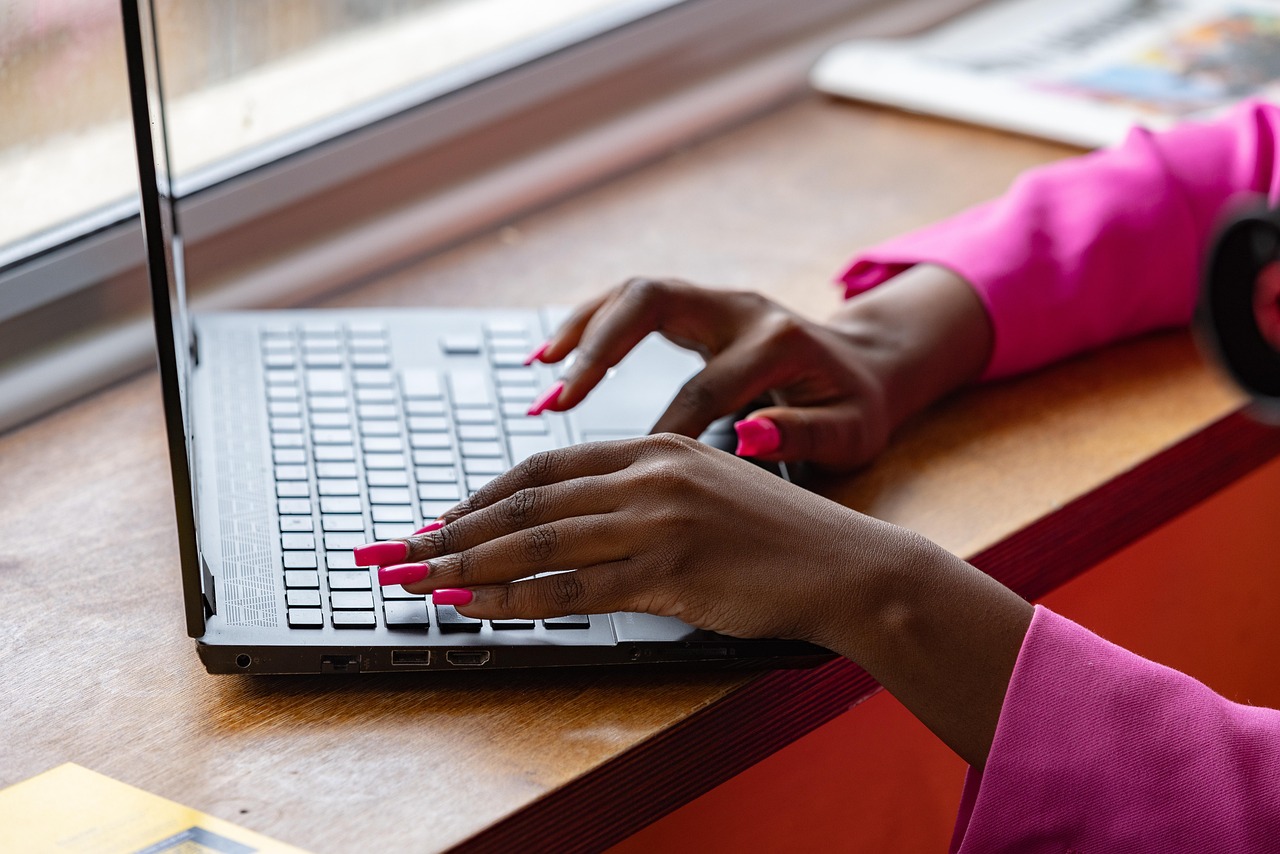 Decorative: close up of hands typing on a laptop